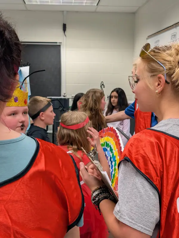Students in costume preparing for performance