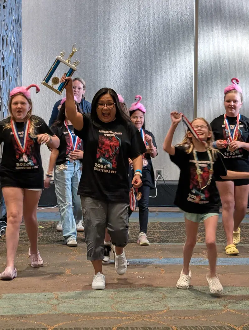 Longleaf OM team celebrating with trophy after state competition